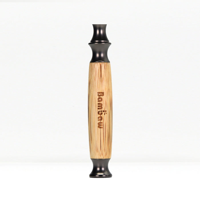 Close up of bamboo razor handle with engraved text along the wood and black end cap