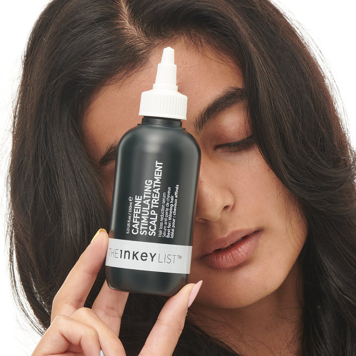 Model holding Caffeine Scalp Treatment