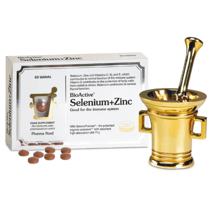 BioActive Selenium+Zinc supplement packaging box shown alongside a gold-colored mortar and pestle and several brown tablets on a white background.