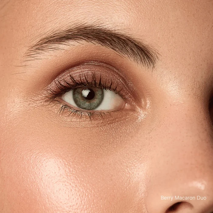 Close-up of a person's eye with makeup, specifically a berry macaron duo.