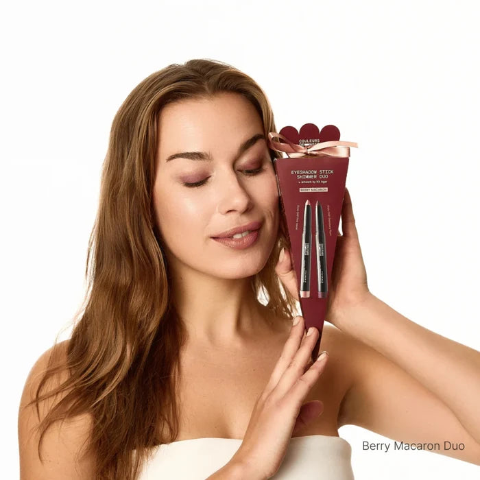 Woman holding a skincare product packaging with 'Berry Macaron Duo' text on a white background