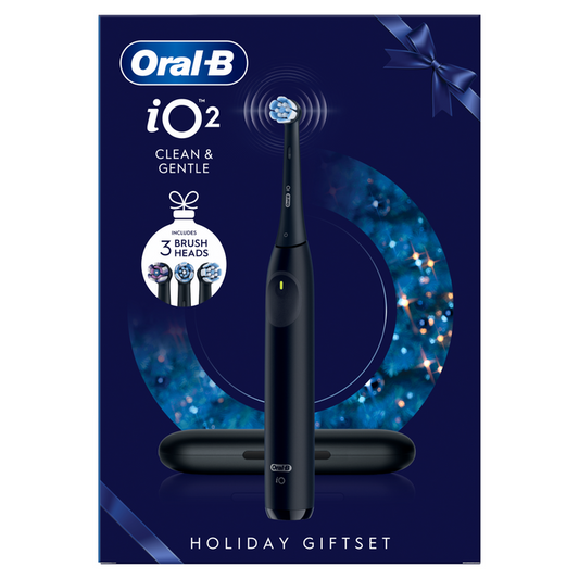 Oral-B iO2 Night Black electric toothbrush holiday gift set box with travel case and 3 brush heads on navy blue background.