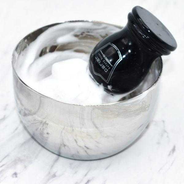 Polished stainless steel shaving bowl with safety razor inside