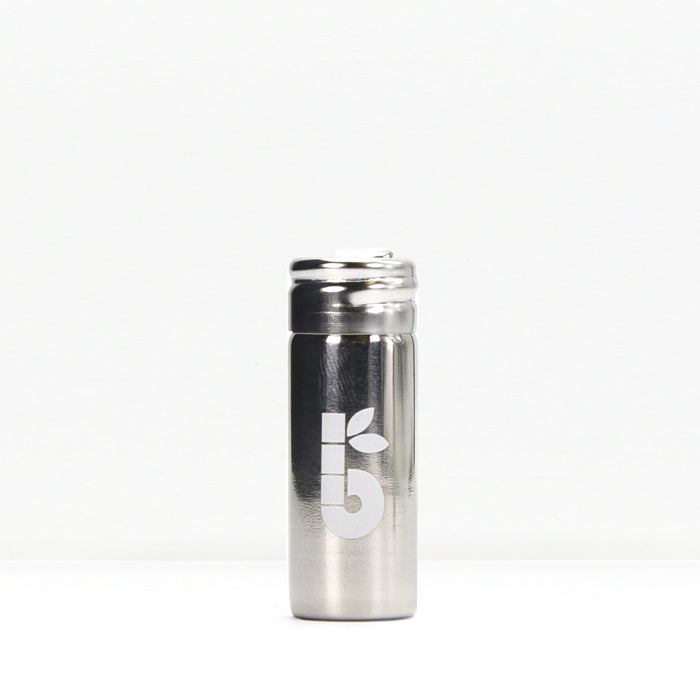 Silk floss product shot showing a small white spool beside a metal container