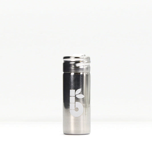 Silk floss product shot showing a small white spool beside a metal container